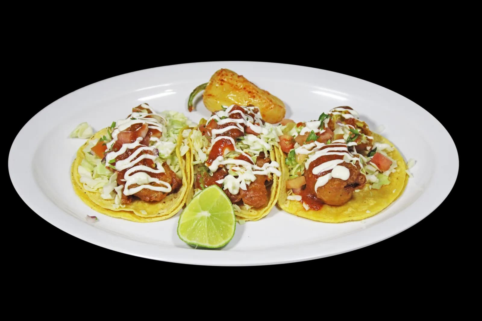 Fish tacos with cabbage, crema, salsa and lime